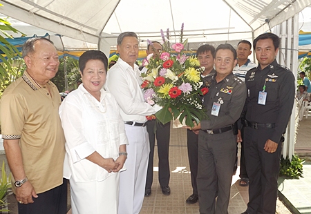 Mai Chaiyanit, mayor of Nongprue City and Khunying Busyarat are all smiles as General Kanit Permsub receives a bouquet of flowers from Pol. Col. Somnuk Changate, superintendent of the Pattaya Police station.