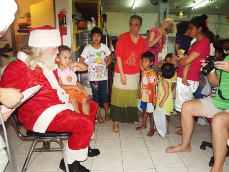 Children wait patiently for their turn to receive a special gift from Santa.