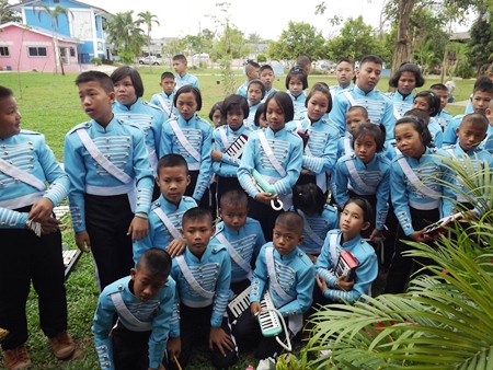 The school band watches with intense interest, perhaps hoping that someday they will be featured performers at the Hard Rock.