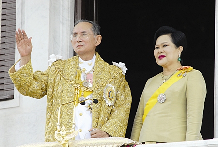 His Majesty the King and HM Queen Sirikit wave to the crowd during ceremonies Friday, June 9, 2006, in Bangkok.