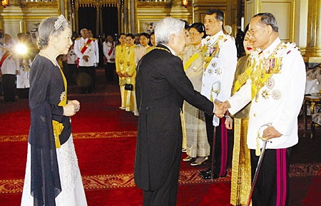 His Majesty the King is congratulated by Japanese Emperor Akihito, as HM Queen Sirikit, partially hidden, and Japanese Empress Michiko look on at the the Ananda Samakhom Throne Hall in Bangkok Monday, June 12, 2006.