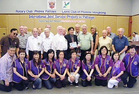 Members of the Rotary Club Phoenix-Pattaya and Lions Club Phoenix Hong Kong pose for a commemorative group photo.