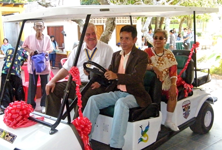 Banglamung Home for the Aged director, Utit Boonchuay sits behind the wheel of the home’s new golf cart.