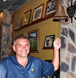 Medal winner Mark Reid rings the bell back at The Golf Club.