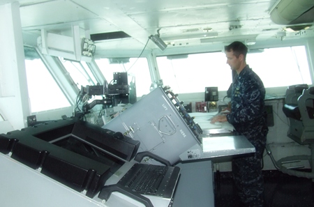 A naval officer goes about his business in the USS Abraham Lincoln control room.