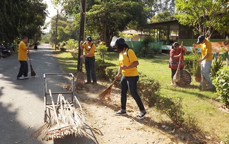 Sailors take time to rake leaves and clean up the grounds around the Banglamung Home for the Elderly.
