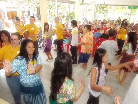 The sailors are invited to participate in a Thai circle dance.