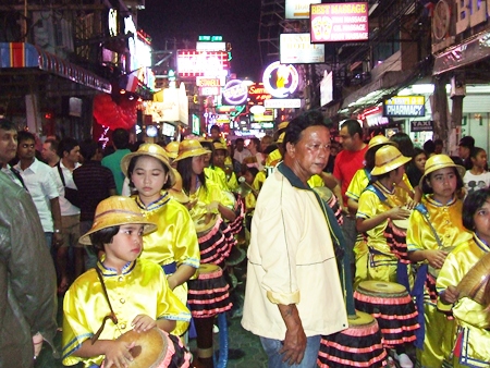 Young long drummers prepare to march through Walking Street.