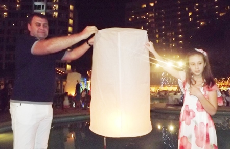Father and daughter prepare to set free a khomloy (Chinese floating lantern) at the Montien Hotel.