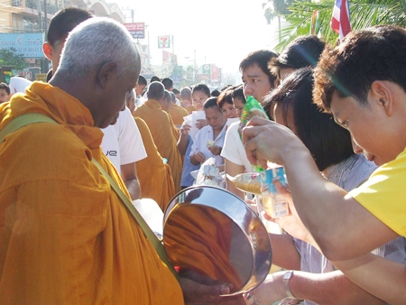 Monks receive alms along Jomtien Beach Road early in the morning on Jan. 1, 2012. 