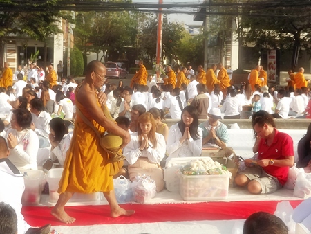 Over 2,000 monks receive alms from over 20,000 humble followers.