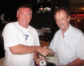 Garry Olliffe (left) receives his Division 1 winner’s prize from Stephen Beard.