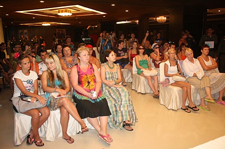 Officials meet with some of the stranded Russian tourists in a town hall style meeting at the Ambassador City Jomtien hotel. 