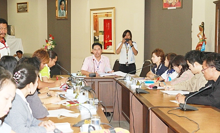 Mayor Itthiphol Kunplome (seated, center) chairs a meeting on AIDS prevention. 