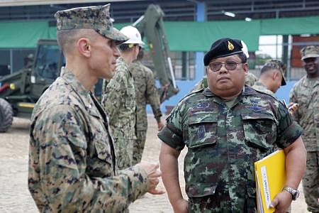 U.S. Marine Corps Lt. Col. Brian Clemens, deputy commanding officer, Combined Joint Military Operations Task Force, Navy Mobile Construction Batallion 40, left, speaks with Royal Thai Army Col. Chaimongkol Pralomram, right, at the Wat Chalheamlap School in Chonburi. (Photo by Cpl. Jessica Olivas) 