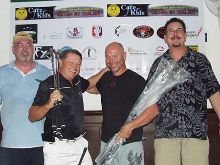 Jon Lay & Kari Kuparinen (center) receive their prizes after finishing first in The Links Challenge charity scramble.
