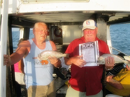 Leif Jansson (right) and Ken Woolley (left) hold up their prize catches. 