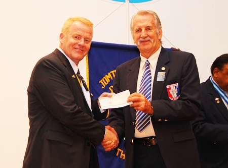 William Macey presents a cheque to President Gudmund to support the club’s humanitarian projects.