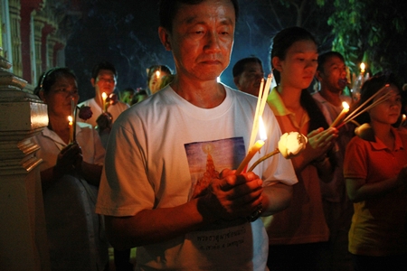 Buddhists quietly walk three times around the temple prayer house, performing the Wien Thien ceremony in the evening at Wat Nong Prue.