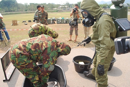 Troops are given a thorough washing after handling toxic chemicals. 