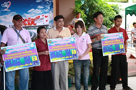 Ministry of Transport officials present vouchers for prosthetic limbs to handicap victims of road accidents. 