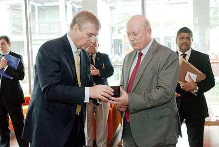 Graham MacDonald, president of the Royal British Legion Thailand presents Prince Andrew with a Legion Coin.
