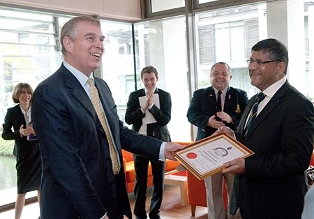 Prince Andrew presents British Ambassador Asif Ahmed with a Friend of the Legion Certificate.