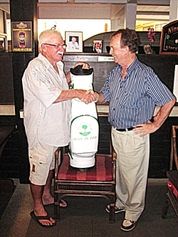 Russell Meiers (left) is all smiles as he accepts his new IPGC golf bag from Stephen Beard of IPGC.