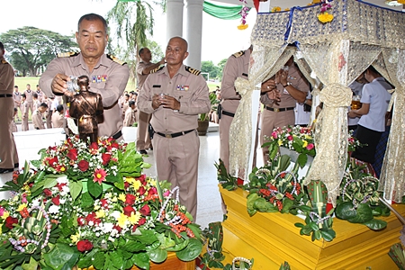 Navy officials and employees of Sattahip Naval base pour water on a Buddha statue and a statue of the Father of the Thai Navy, to celebrate Songkran.