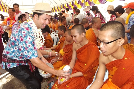 Mayor Itthiphol Kunplome pours lustral water on young monks at Wat Chaiyamongkol in South Pattaya.