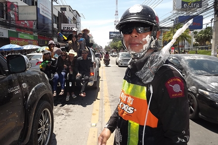 Officers work hard to help clear traffic even though they are often targets of water and powder during Wan Lai Pattaya.