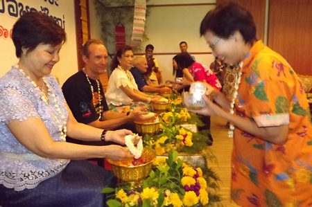 (L to R) Sopin Thappajug, Lewis Woody Underwood, Nittaya Patimasongkroh, Bernie Tuppin and Elfi Seitz have lustral water poured on their hands at the Songkran festivities at the Diana Garden Resort.