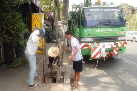 Pattaya Engineering Department workers clear storm drains along Second Road. 