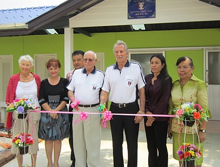 Benefactors and guests cut the ribbon to officially open the new facilities. 