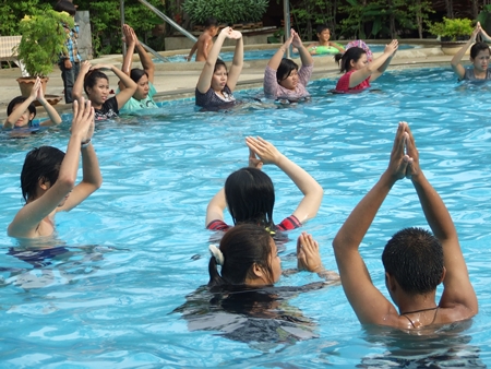 Expecting mothers and their families take part in hydrotherapy exercises at the Diana Garden Resort pool. 