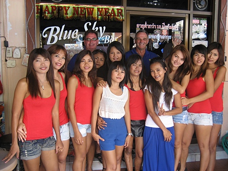 Andy Oz and Tony Cowe (standing rear) pose with the staff outside Blue Sky Bar. 