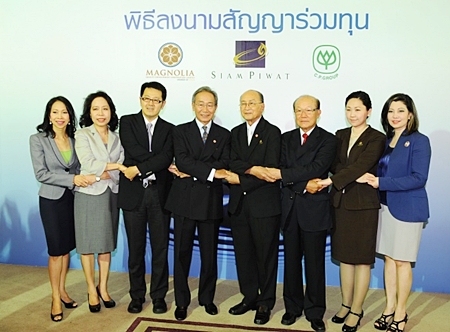 Executives of Siam Piwat and Magnolia Quality Development, together with the CP Group pose at a press conference to announce the new 35 billion baht development. 