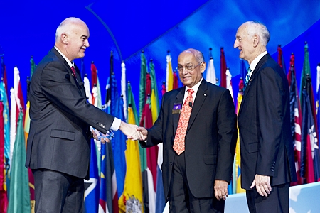 R.I. President Kalyan Banrjee congratulatesJohn Skerritt (left) as he receives the 2011-12 Global Alumni Service to Humanity Award from Rotary Foundation Trustee Chair William B. Boyd.