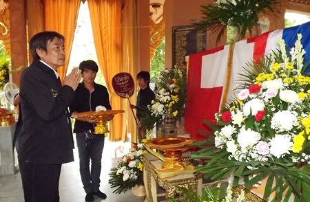 Deputy Mayor Ronakit Ekasingh presents a robe dedicated to the departed.