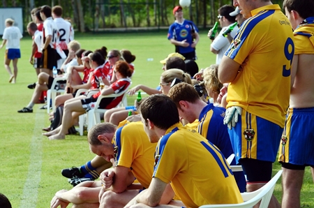 Fans and players cheer on from the touchline. 