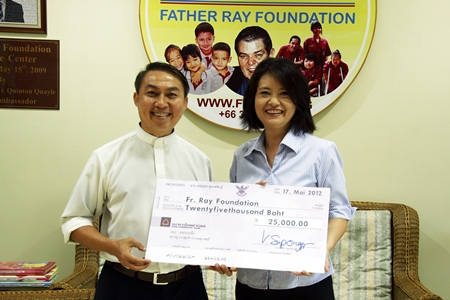Vanvara Supongspun (right) presents a cheque for 25,000 baht to Father Pattarapong in aid of the Father Ray Foundation. The funds were raised at a recent party held at the Vanvaras German School located on Sukhumvit Road in Pattaya.