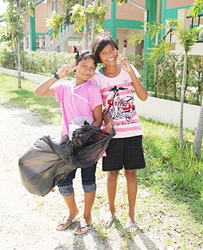 Some of the children keep busy happily collecting rubbish on the land.