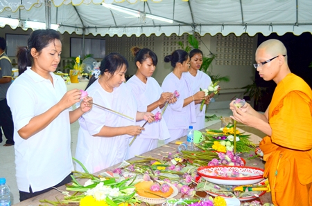 Buddhists prepare offerings to be used in the Wien Thien ceremony at Wat Khao Phra Yai.