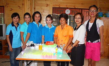 Praichit Jetapai (center) and members of the YWCA Bangkok-Pattaya Center present medicine to Boonchu Muangmaitong, principal of the Boonchu House for children with special needs.