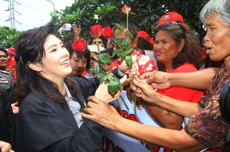 Prime Minister Yingluck Shinawatra is mobbed by her devoted fans in Laem Chabang. 