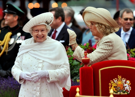 Britain’s Queen Elizabeth II, left, and Camilla, Duchess of Cornwall, speak while on the royal barge during the Diamond Jubilee Pageant on the River Thames in London, Sunday, June 3. (AP Photo/John Stillwell, Pool)