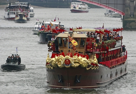 The Royal Barge after passing under Lambert Bridge during the Thames Diamond Jubilee River Pageant in London, Sunday, June 3. More than 1,000 boats sailed down the Thames on Sunday in a flotilla tribute to Queen Elizabeth II’s 60 years on the throne that organizers are calling the biggest gathering on the river for 350 years. Despite cool, drizzly weather, hundreds of thousands of people lined the riverbanks in London, feting the British monarch whose longevity has given her the status of the nation’s favorite grandmother. (AP Photo/Tim Hales)