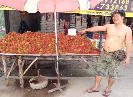 Rambutan vendor Thew Janthakhram says he’s doing well enough that he’ll even give away extra fruit with big purchases. 
