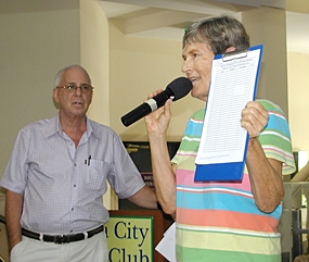 Pat Koester announces the sign up sheet for a trip to some of the older cultural sights of Samut Prakan, while MC Richard Silverberg looks on.