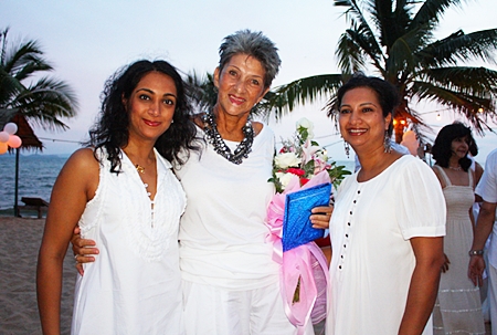 Anou McPherson (left) and Rachna Rao (right) say happy birthday to Pat Burbridge.